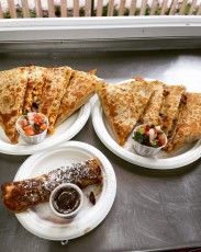 two egg quesadillas with sides of house made Pico and a bacon roll-up